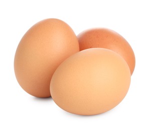 Photo of Three raw chicken eggs isolated on white