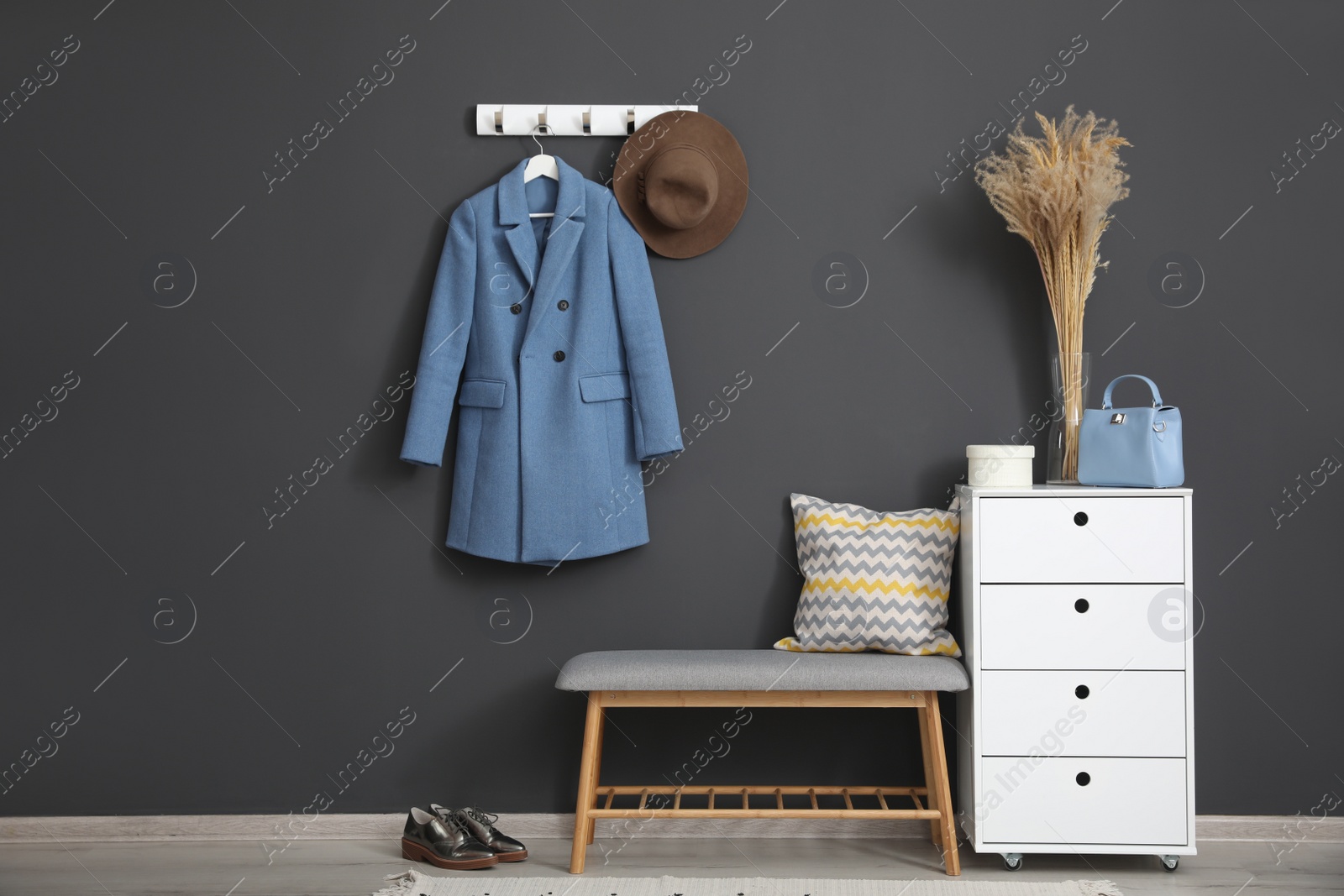 Photo of Hallway interior with stylish furniture, clothes and accessories
