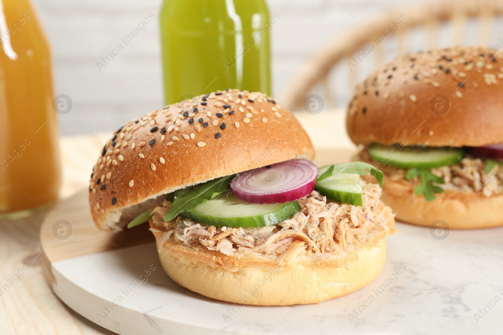 Photo of Delicious sandwiches with tuna and vegetables on serving board, closeup