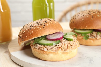 Photo of Delicious sandwiches with tuna and vegetables on serving board, closeup