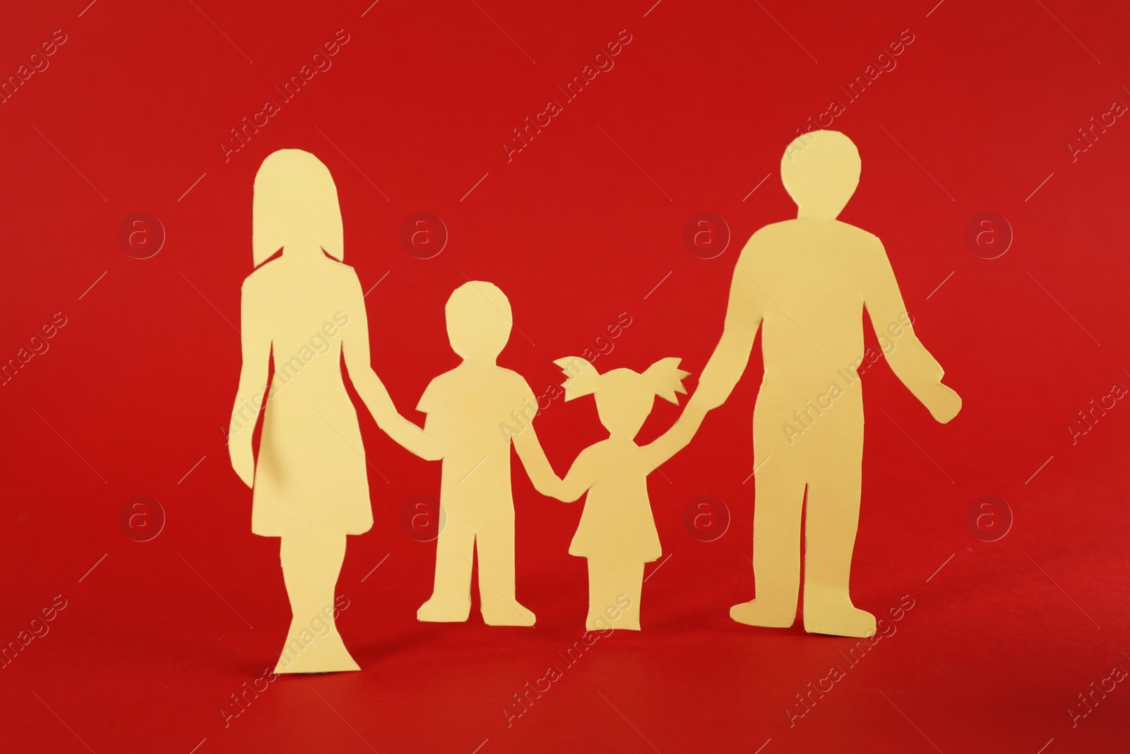 Photo of Paper family figure on red background. Child adoption concept