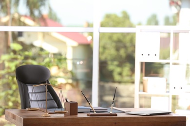 Table with scales of justice in lawyer's office