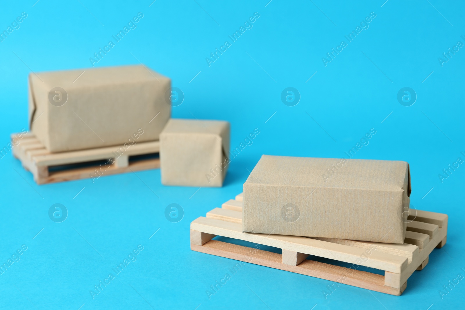 Photo of Wooden pallets and boxes on light blue background