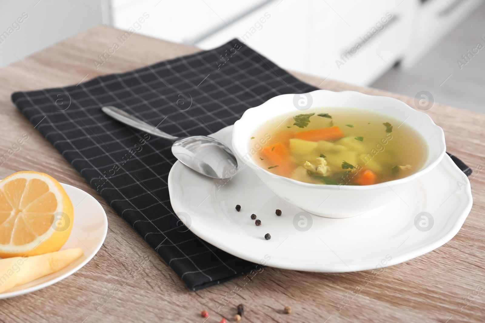 Photo of Bowl with delicious hot broth on table. Cold treatment