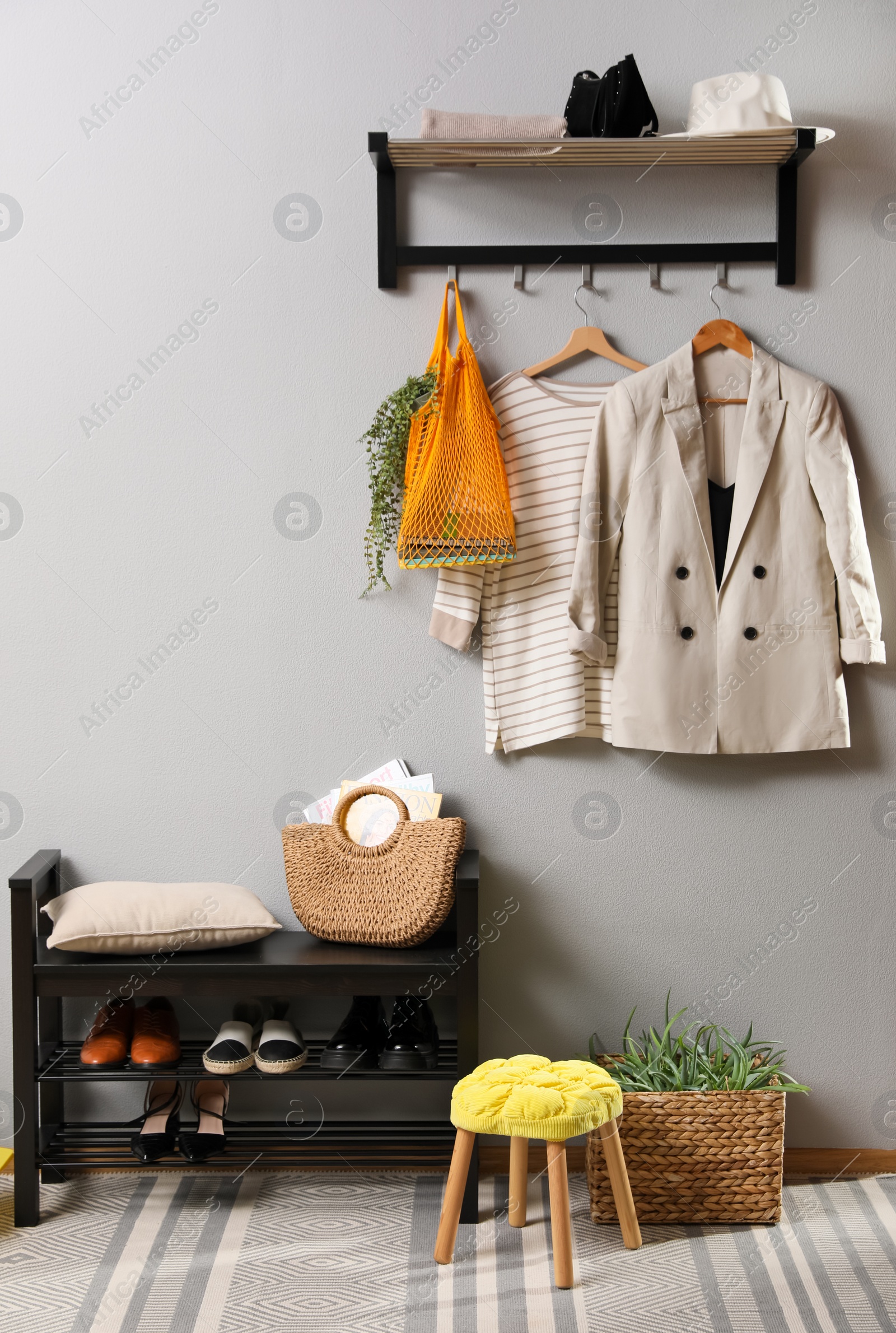 Photo of Hallway interior with stylish furniture, clothes and accessories