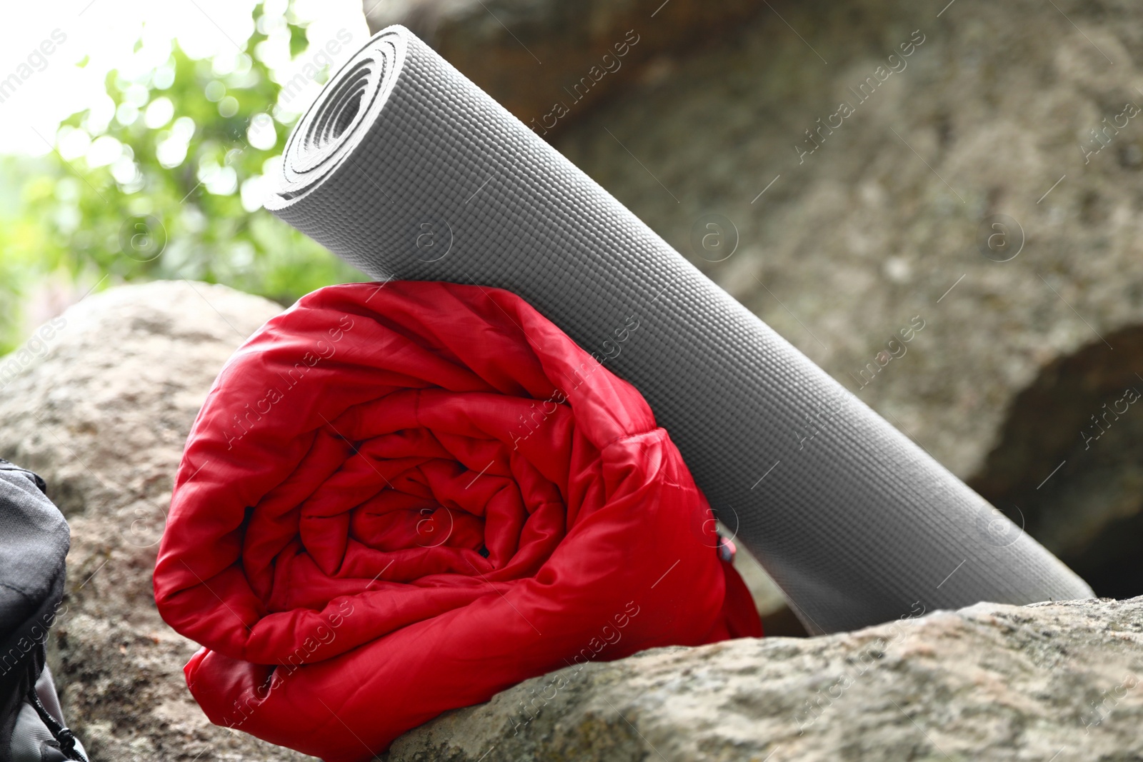 Photo of Rolled sleeping bag and mat on rock