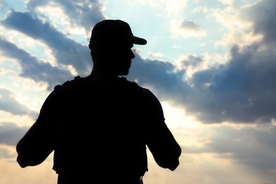 Photo of Soldier in uniform patrolling outdoors. Military service