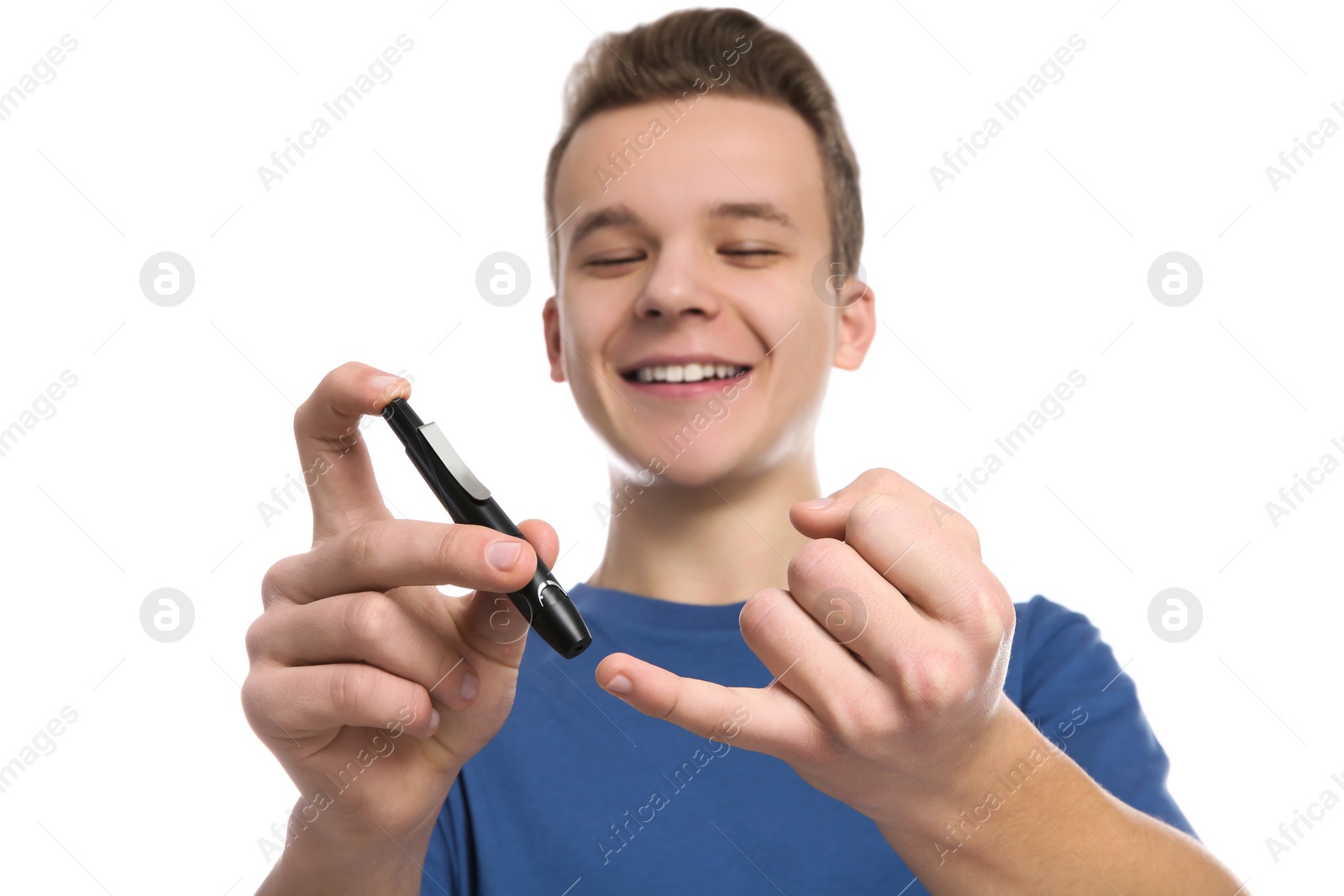 Photo of Teen boy using lancet pen on white background. Diabetes control