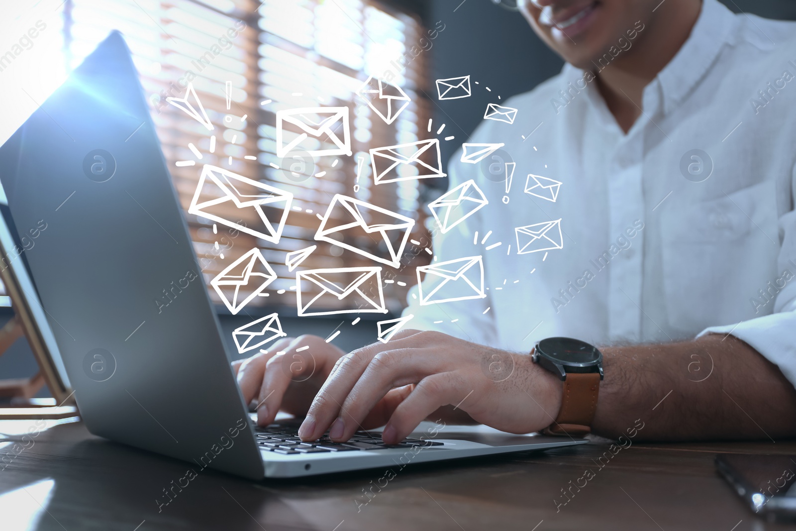 Image of Businessman sending emails at table indoors, closeup