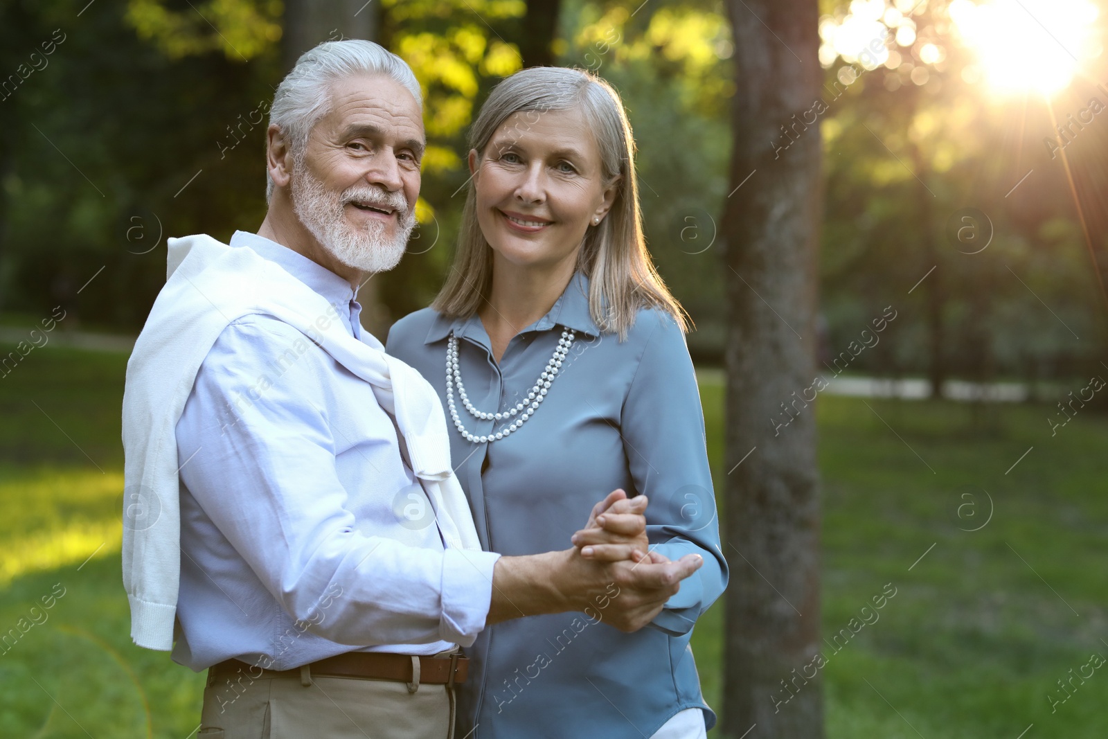 Photo of Affectionate senior couple spending time together in park, space for text. Romantic date