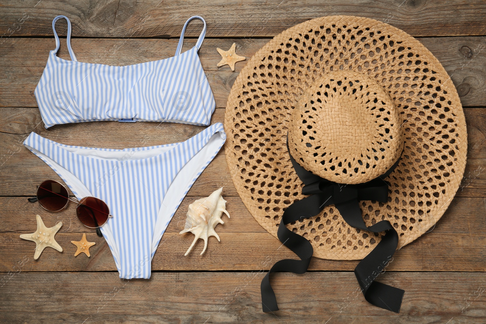 Photo of Flat lay composition with beach accessories on wooden background