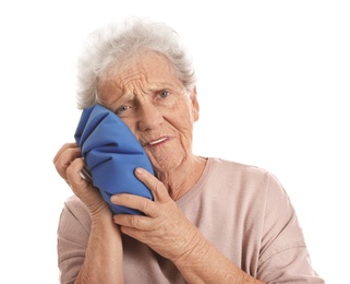 Senior woman suffering from toothache on white background