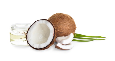 Photo of Ripe coconuts and jar with natural organic oil on white background