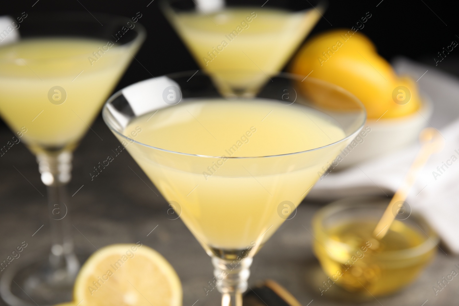 Photo of Delicious bee's knees cocktail on grey table, closeup