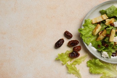 Delicious parsnip with lettuce, feta cheese and dates on beige table, flat lay. Space for text