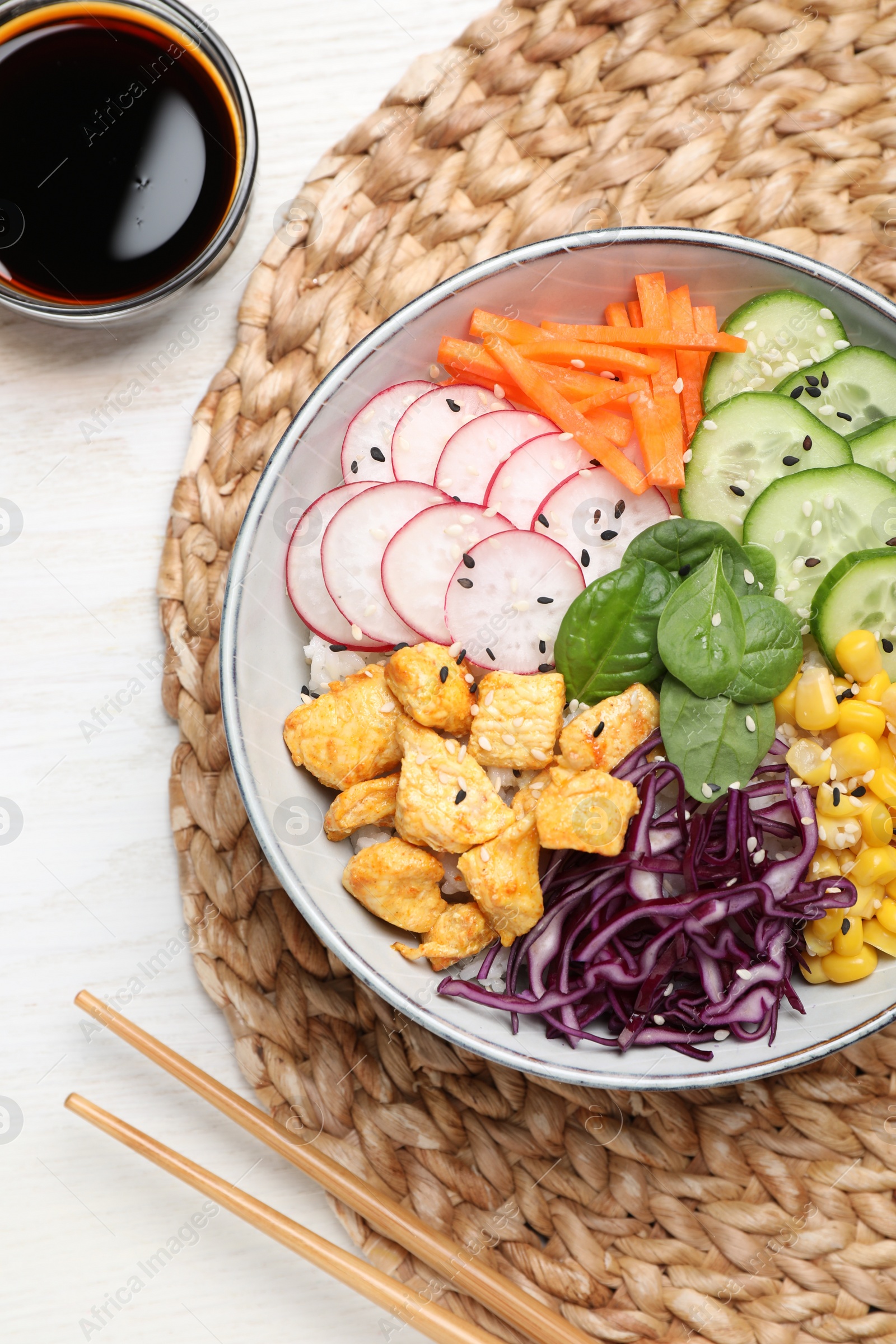 Photo of Delicious salad with chicken, vegetables and spinach on white wooden table, flat lay