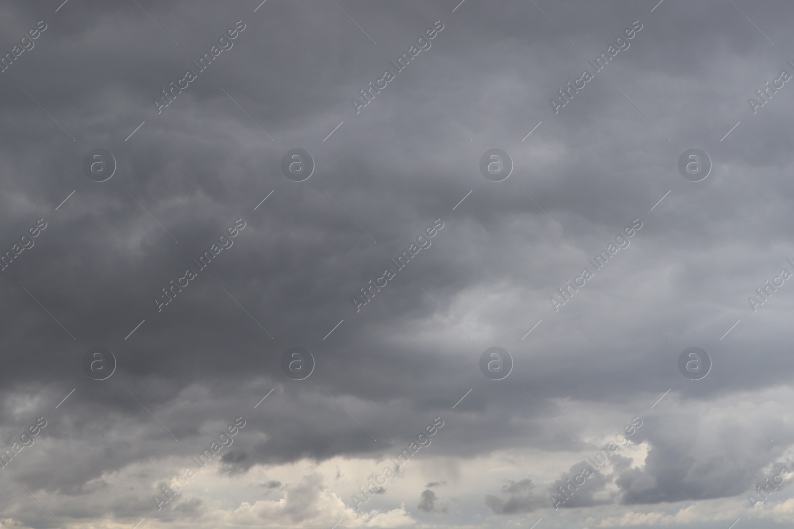 Photo of Sky with heavy rainy clouds on grey day