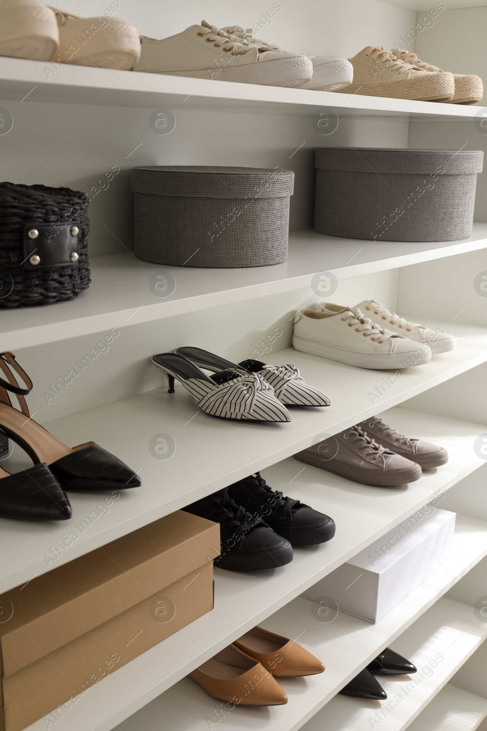 Photo of Storage rack with stylish women's shoes and accessories