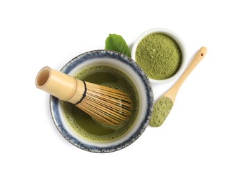 Cup of fresh matcha tea with bamboo whisk and green powder isolated on white, top view