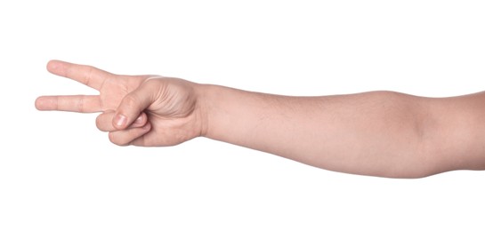 Photo of Playing rock, paper and scissors. Man making scissors with his fingers on white background, closeup