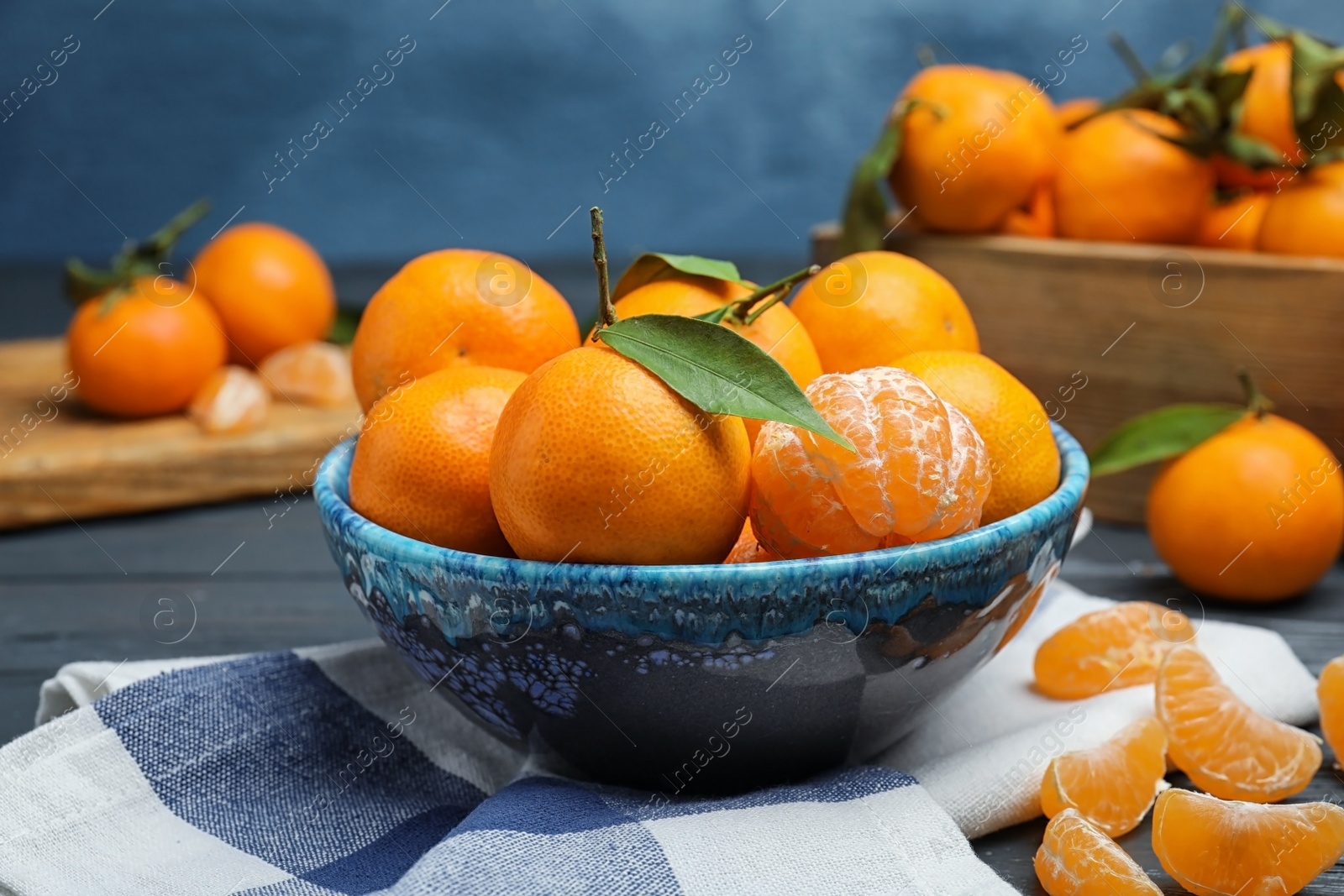 Photo of Fresh ripe tangerines in bowl on table