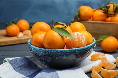 Fresh ripe tangerines in bowl on table