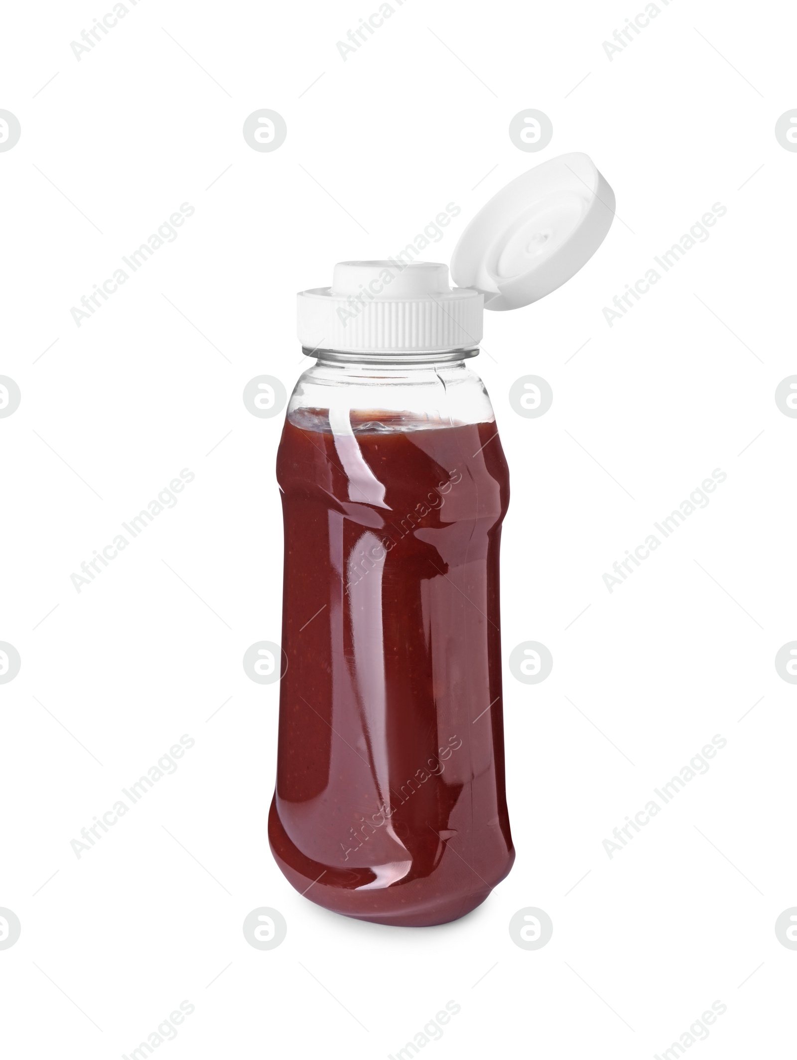 Photo of Bottle of tasty ketchup isolated on white