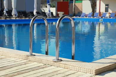 Photo of Modern swimming pool with ladder at resort