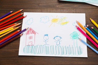 Photo of Cute child`s drawing and colorful pencils on wooden table, flat lay