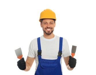 Photo of Professional worker with putty knives in hard hat on white background