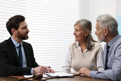 Senior couple having meeting with lawyer in office