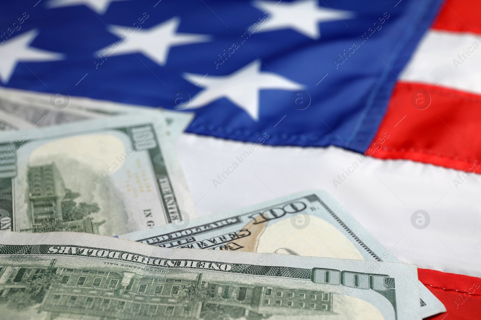 Photo of Pile of dollars on national USA flag