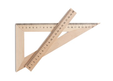 Wooden triangle with measuring length markings and ruler isolated on white, top view