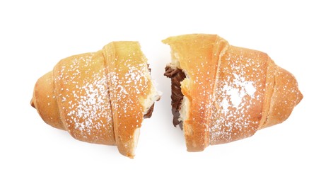 Photo of Halvestasty croissant with chocolate and sugar powder on white background, top view