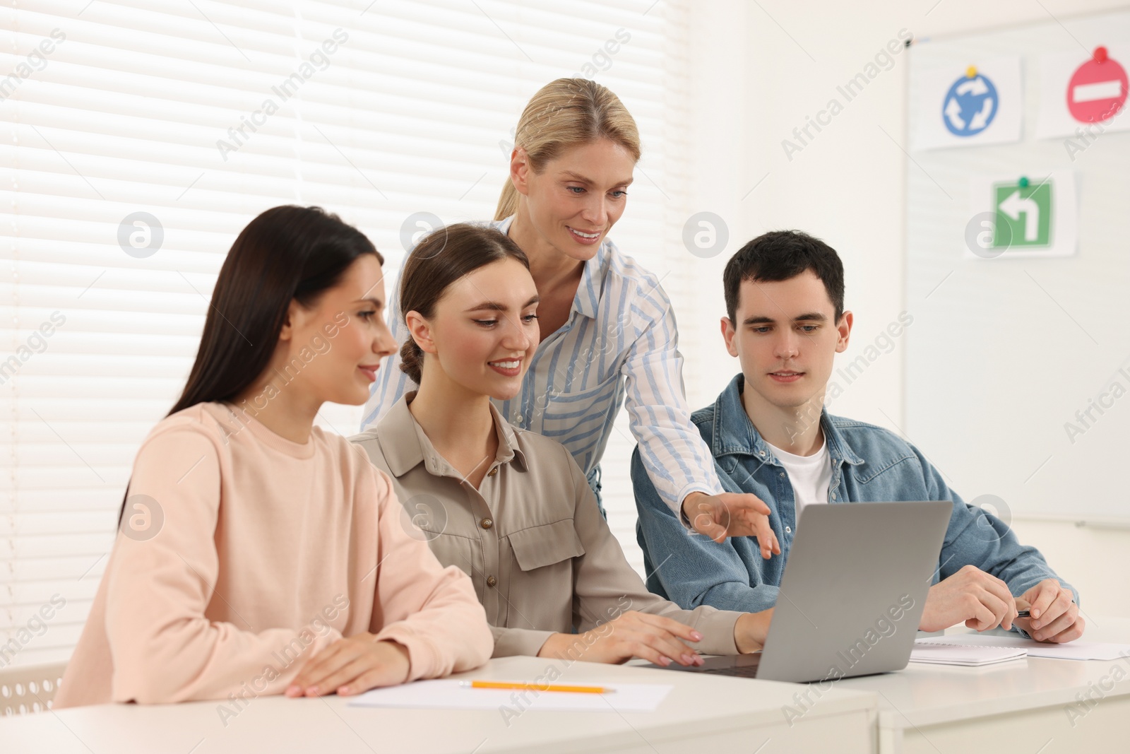 Photo of Happy teacher giving lesson in driving school