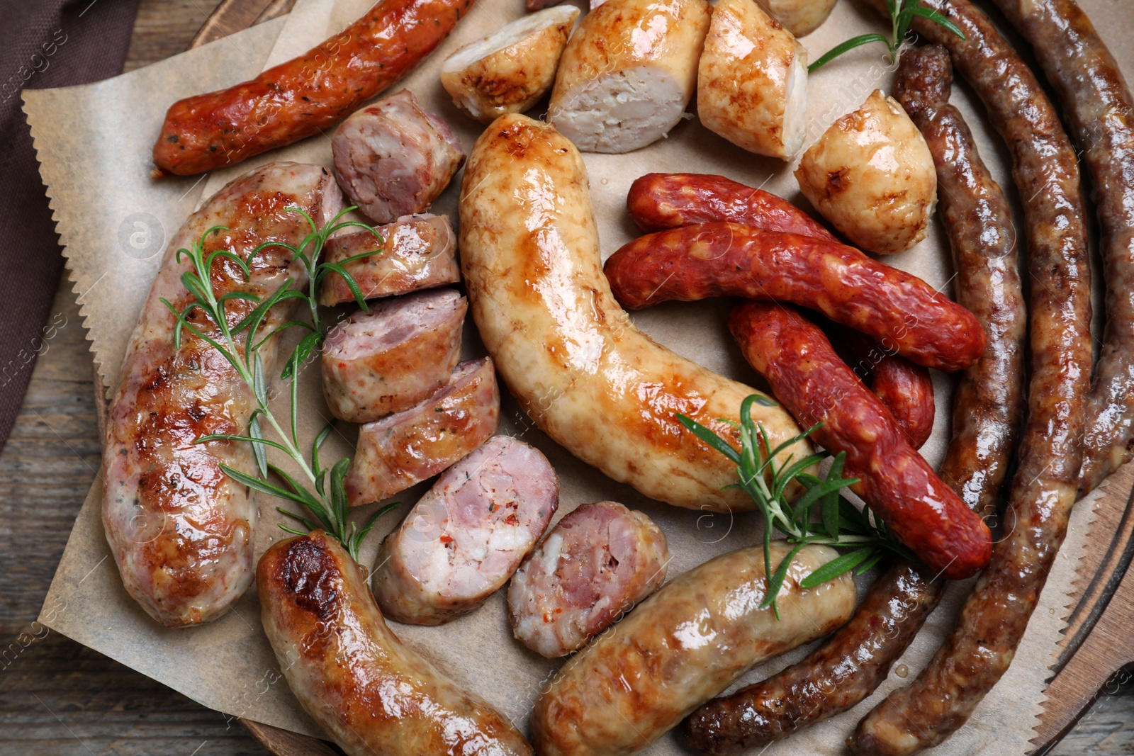 Photo of Set of different tasty snacks on wooden table, top view