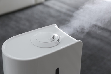 Photo of Modern air humidifier at home, closeup view