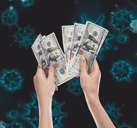 Image of Be careful with money during coronavirus outbreak. Woman with cash on dark background, closeup