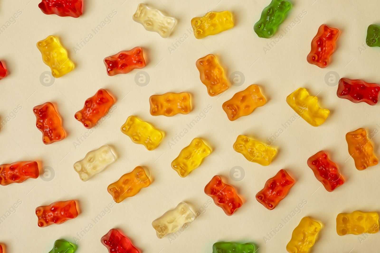 Photo of Flat lay composition with delicious jelly bears on color background