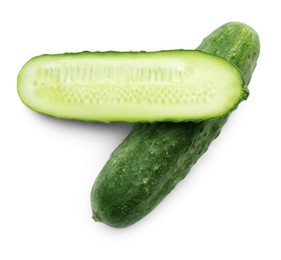 Photo of Whole and cut cucumbers on white background, top view