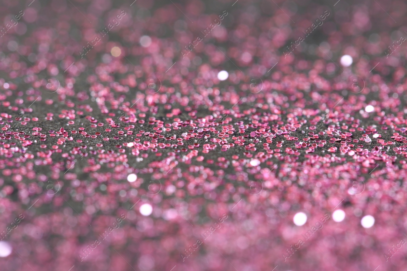 Photo of Pink glitter with bokeh effect on dark background