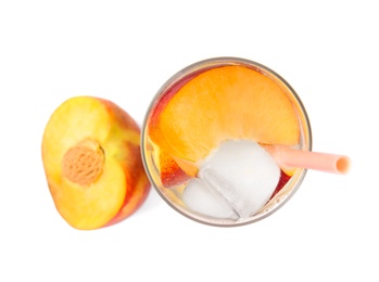 Delicious refreshing peach cocktail in glass and fresh fruit on white background, top view