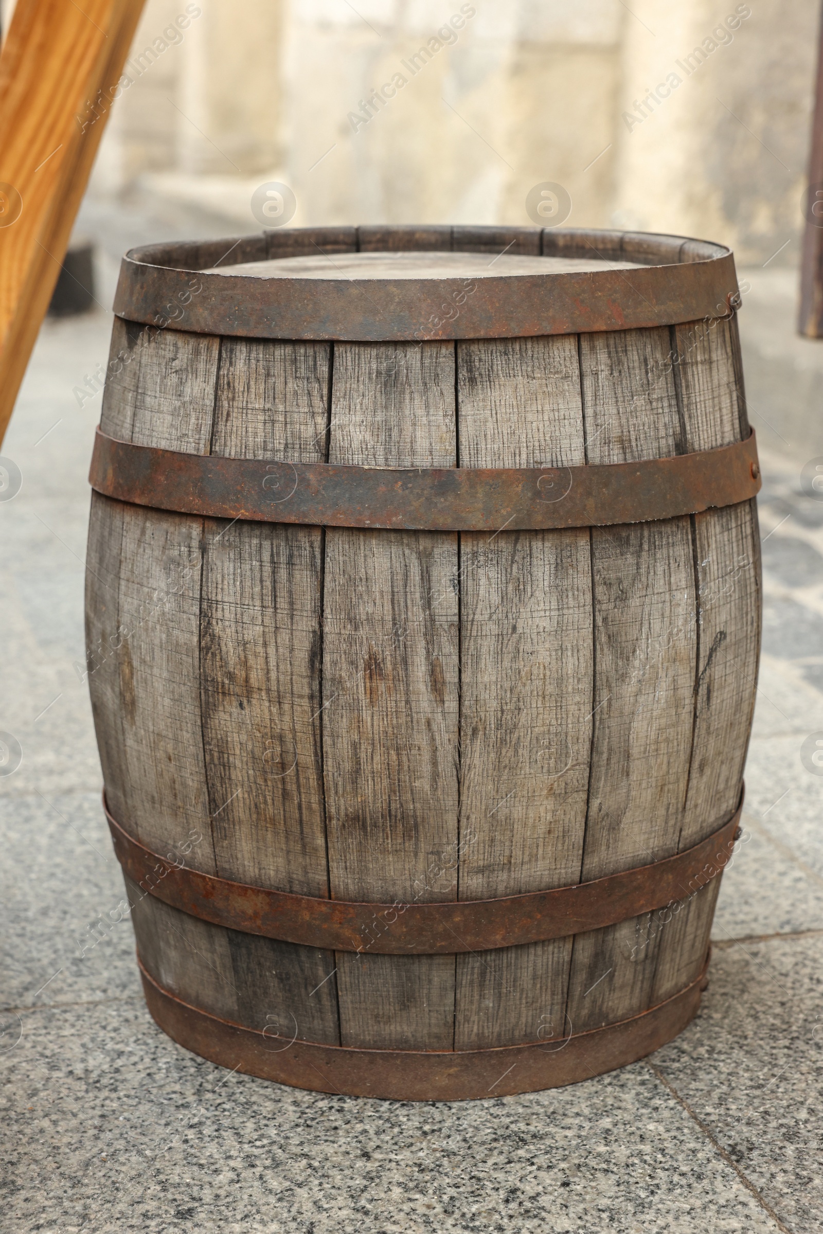 Photo of Traditional wooden barrel on street outdoors. Wine making