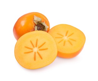 Photo of Whole and cut persimmon fruits isolated on white, top view