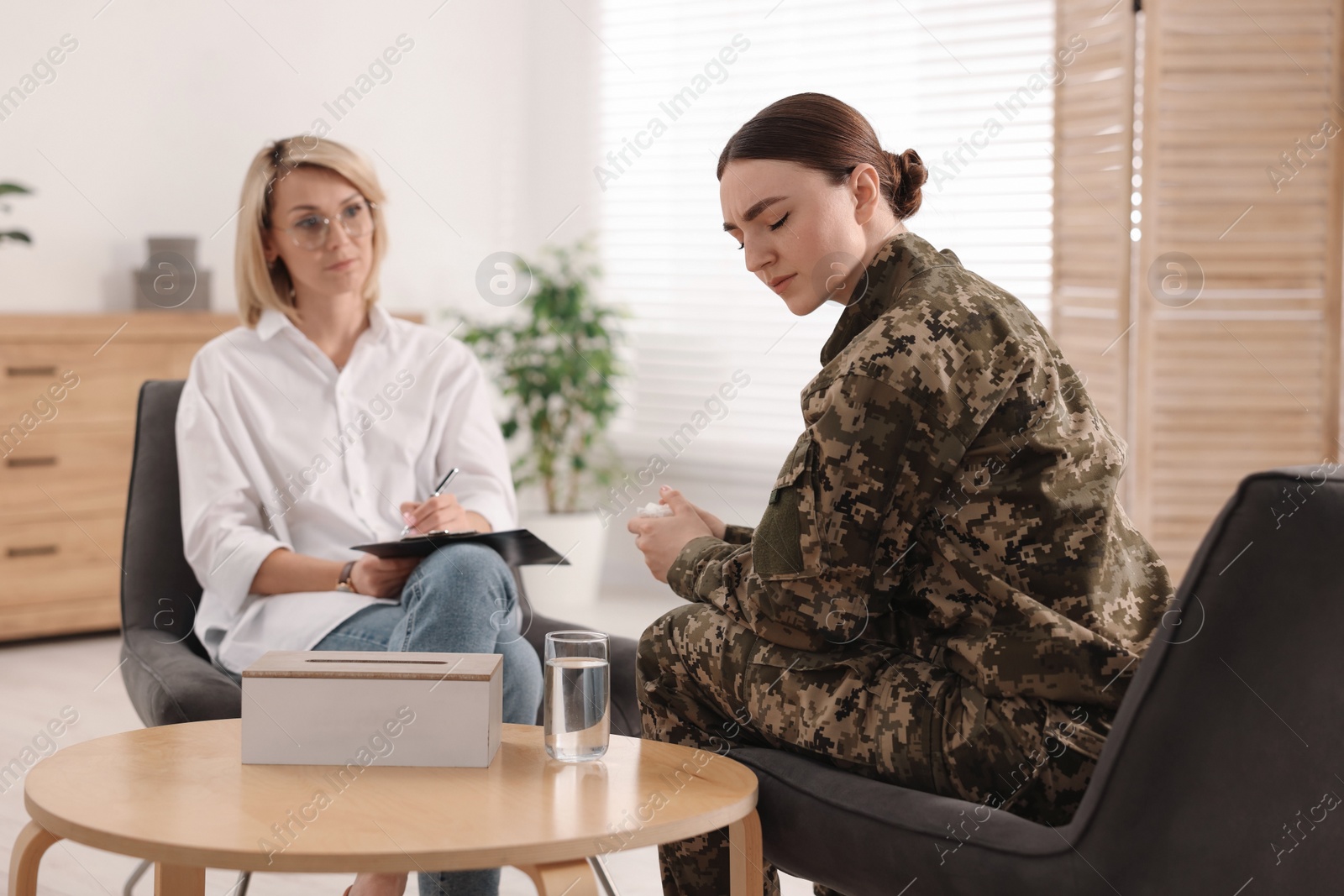 Photo of Psychotherapist working with military woman in office