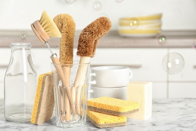 Cleaning supplies for dish washing and soap bubbles in kitchen