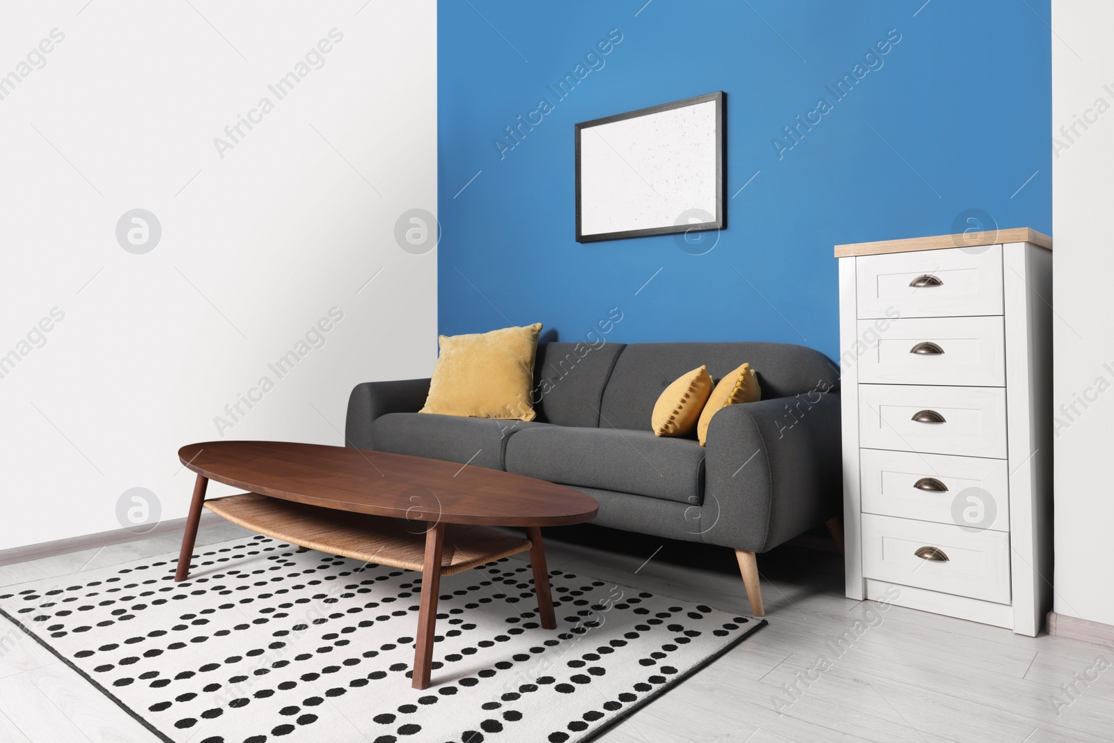 Photo of Stylish living room interior with comfortable sofa and coffee table