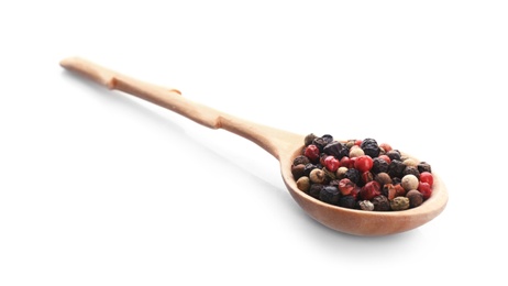 Wooden spoon with different pepper grains on white background