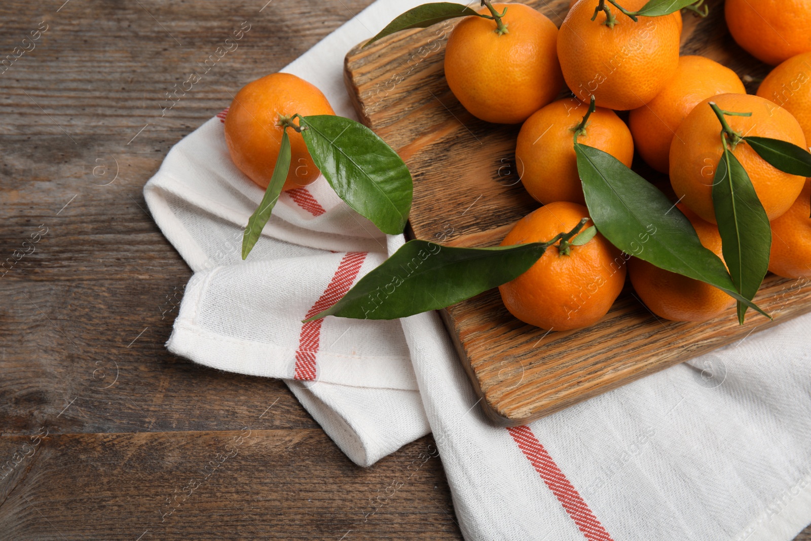 Photo of Composition with fresh ripe tangerines on wooden background