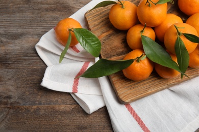 Photo of Composition with fresh ripe tangerines on wooden background